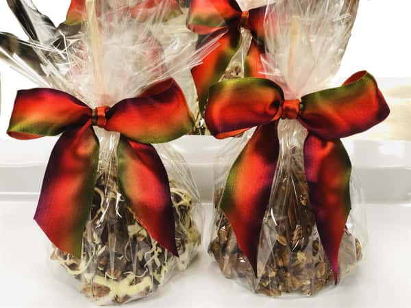 two caramel apples wrapped up