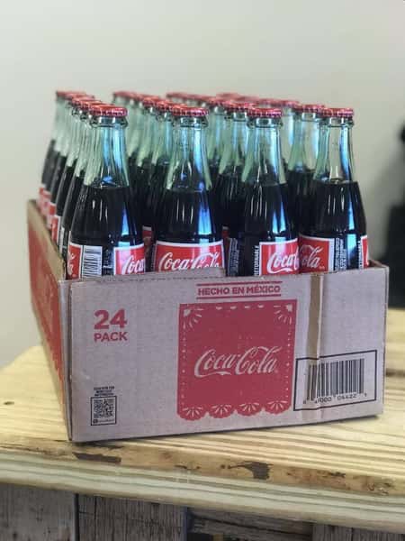 A 24 pack of glass Coca Cola bottles