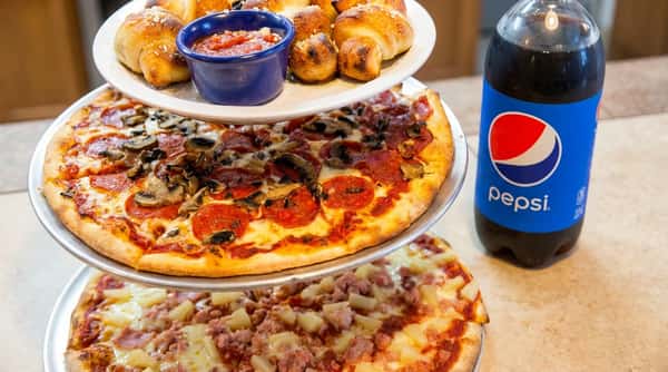 Three-tier pizza stand with garlic knots and marinara, pepperoni and mushroom pizza, and ham and pineapple pizza.