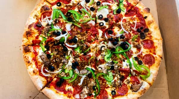 Pepperoni, sausage, green pepper, onion, black olive, and mushroom pizza with a golden crust.