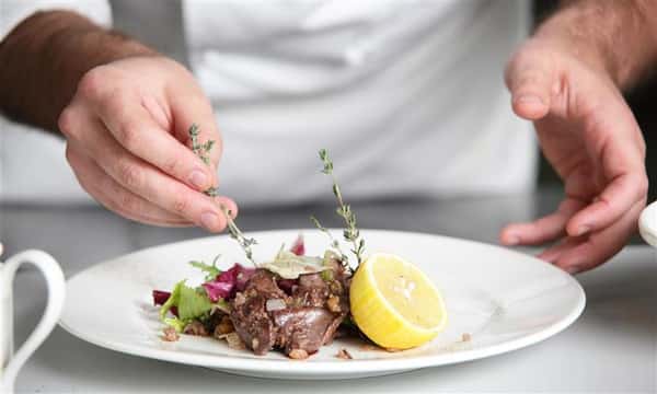 chef preparing plate of food
