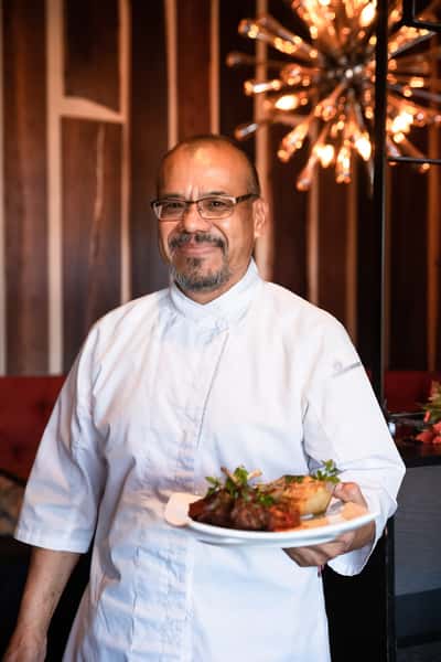 Chef Lucio holding a plate