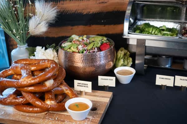 Spread of shared appetizers, burgers, and entrées arranged on a table for a group dining event in Oviedo, FL