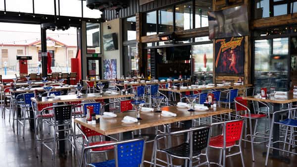 Wide view of the outdoor patio set up with tables for a large event in Oviedo, FL