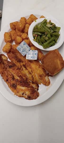 Fried fish fillets with tater tots, green beans and cornbread