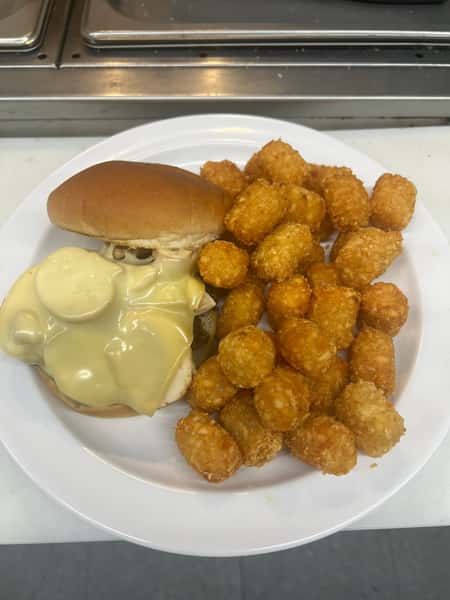 Sandwich with tater tots and a creamy side