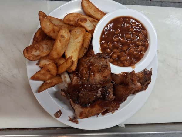 BBQ pork with potato wedges and baked beans