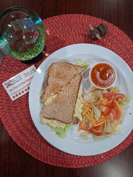 Sandwich with a side salad and dressing
