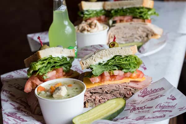 Roast beef and ham sandwich with a side of chicken noodle soup