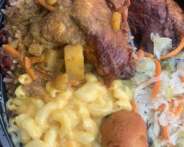Jamaican combo plate with curry goat, fried chicken, mac and cheese, cabbage slaw, rice and peas, and a golden festival dumpling.