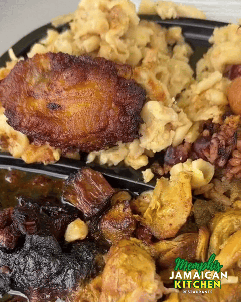 Jamaican meal with mac and cheese, fried plantain, rice and peas, oxtail, and curry chicken from Memphis Jamaican Kitchen.