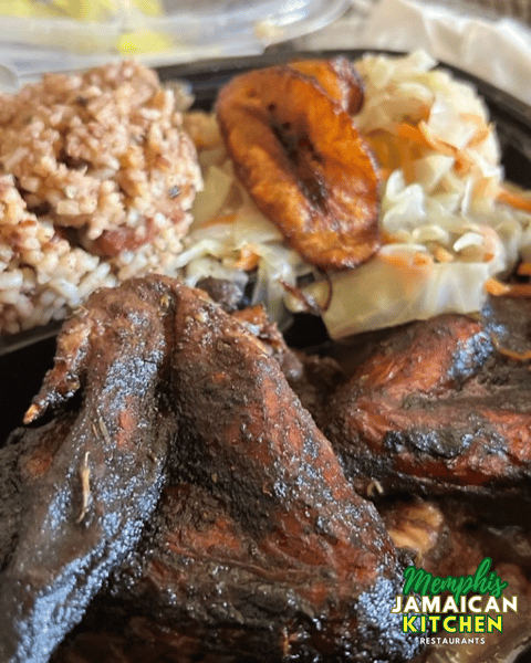Jerk chicken with rice and peas, fried plantain, and steamed cabbage from Memphis Jamaican Kitchen.
