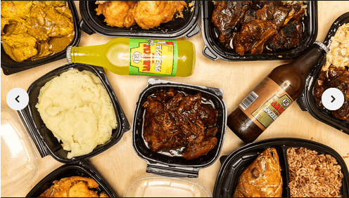 This spread showcases a variety of Jamaican dishes including curry chicken, oxtail, stewed chicken, fried chicken, mashed potatoes, rice and peas, and a whole fish entrée — all accompanied by authentic Jamaican beverages like Ting and a glass bottle soda. A vibrant and hearty Caribbean feast!