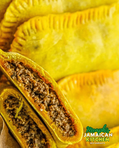 Golden Jamaican beef patties with flaky crust and seasoned meat filling, branded with Memphis Jamaican Kitchen logo.