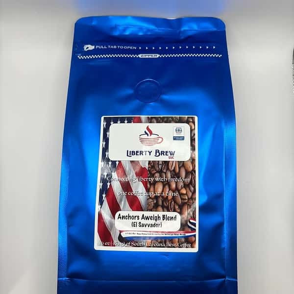 Bag of Liberty Brew's Anchors Aweigh Blend coffee sourced from El Salvador, featuring bold blue patriotic packaging with roasted beans and an American flag.