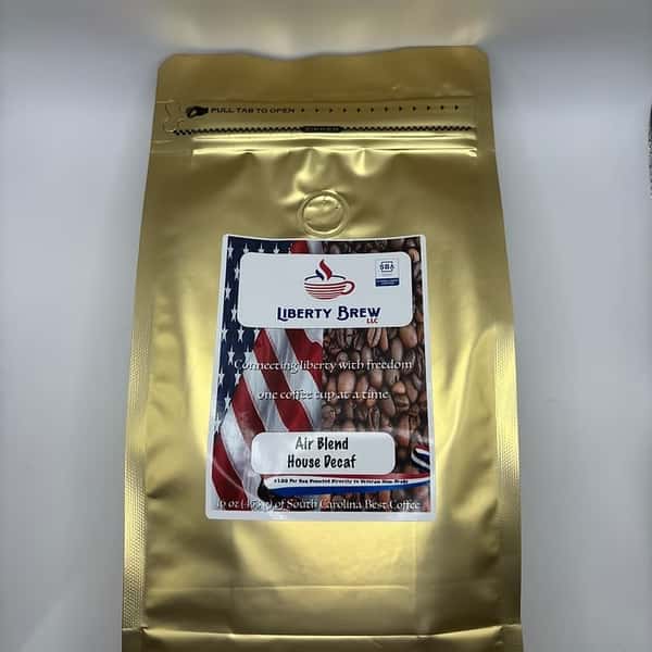 Gold foil bag of Liberty Brew's Air Blend House Decaf coffee, featuring premium packaging with a bold American flag and coffee bean imagery.