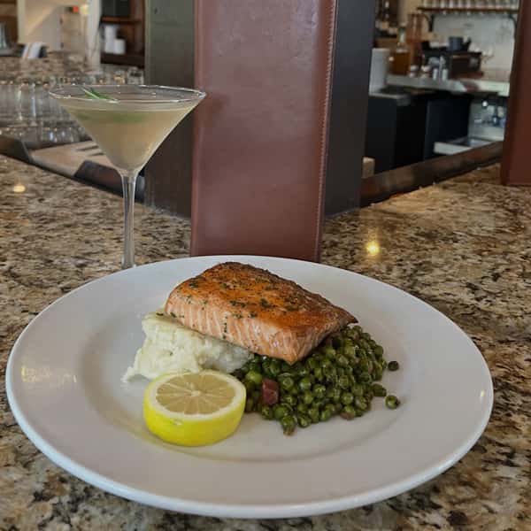 Grilled salmon served with peas and mashed potatoes