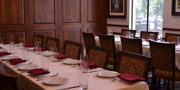 Dining tables and chairs setup with place settings