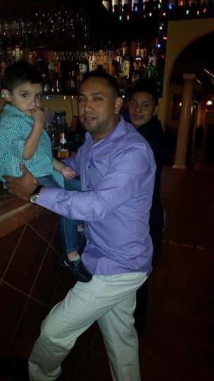man and young boy posing for picture