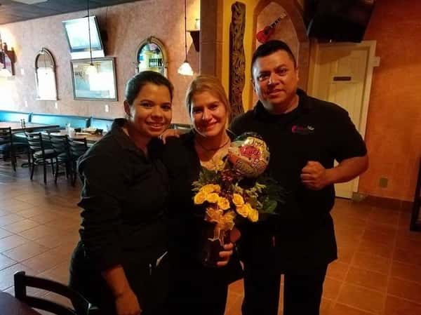 three people posing for picture
