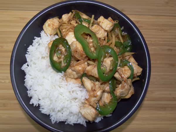 Chicken ginger with jalapenos over a bed of white rice.