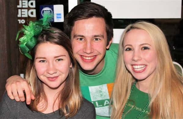 Two females, one male smiling for photo