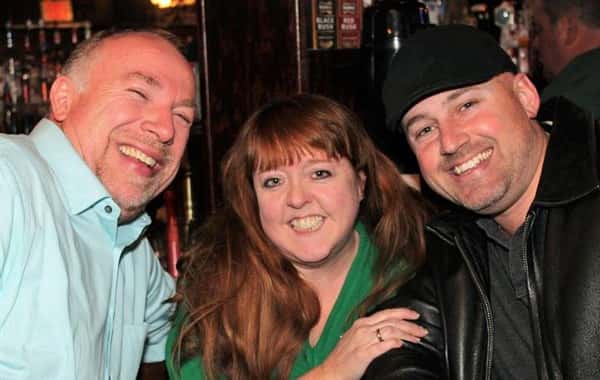 Three people in picture, all are smiling