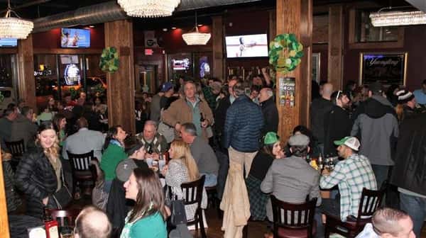 Large room inside restaurant filled with customers