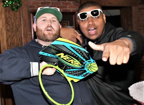 Two males in photo, one is wearing sunglasses and pointing finger