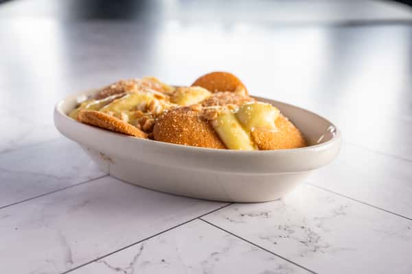 banana pudding dessert with vanilla wafers, creamy custard, and crushed cookie topping