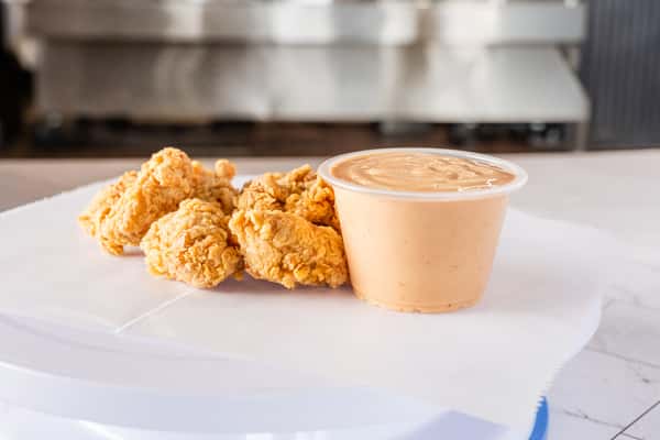 crispy fried chicken tenders served with creamy dipping sauce, Southern-style appetizer plate