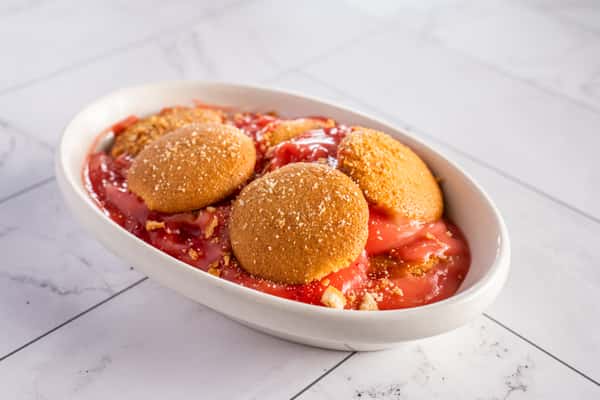 Strawberry pudding dessert with vanilla wafers, creamy custard, and crushed cookie topping