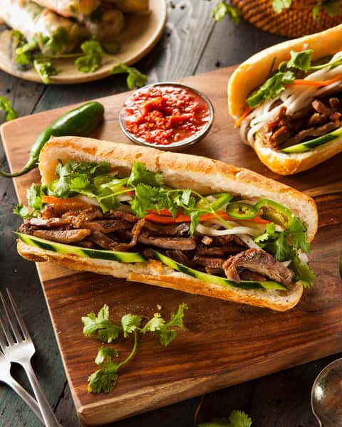 Craving something fresh and flavorful? Look no further than Koi Pond's Banh Mi! Our mini-baguette is stuffed with a delicious combination of fresh and pickled veggies, duck pate, and a fried egg. Plus, you can customize it to your liking! 😋👌 Bring the whole family and try it today! #BanhMi #FamilyFriendly #KoiPondMenu