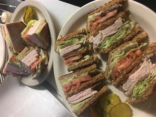turkey sandwiches with pickles on the side
