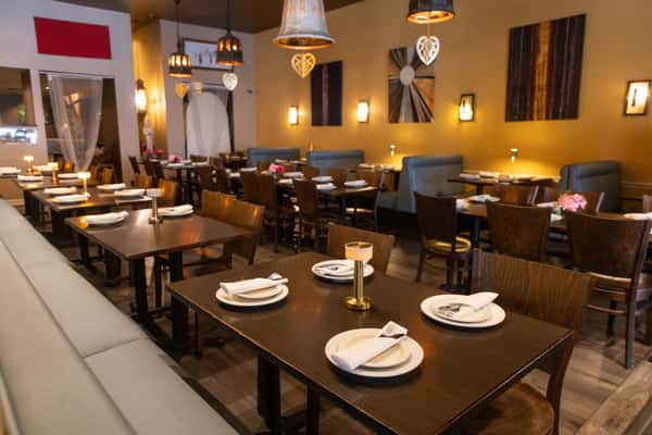 Elegant lighting, modern Thai-inspired décor, and beautifully arranged table settings create a warm and inviting atmosphere perfect for family dinners, date nights, and special occasions.