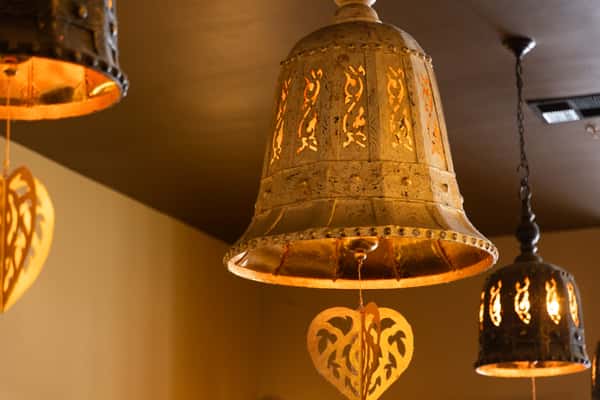 Intricately crafted pendant lighting brings warm golden ambiance and authentic Thai-inspired elegance, adding a cozy and sophisticated touch to the dining experience.