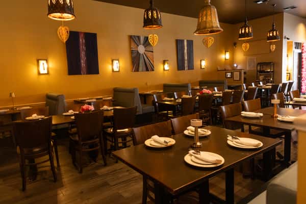 Warm lighting, elegant décor, and thoughtfully arranged dining tables create a cozy Thai-inspired atmosphere perfect for intimate dinners, family gatherings, and special occasions.