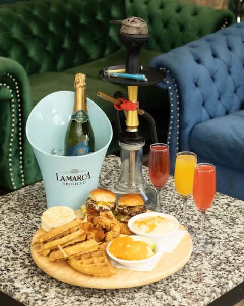 Champagne brunch spread at Sivas Tavern featuring waffles, mimosas, and upscale brunch dining atmosphere