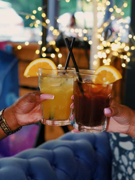 Guests toasting tropical cocktails at Sivas Tavern with vibrant nightlife and upscale lounge vibes