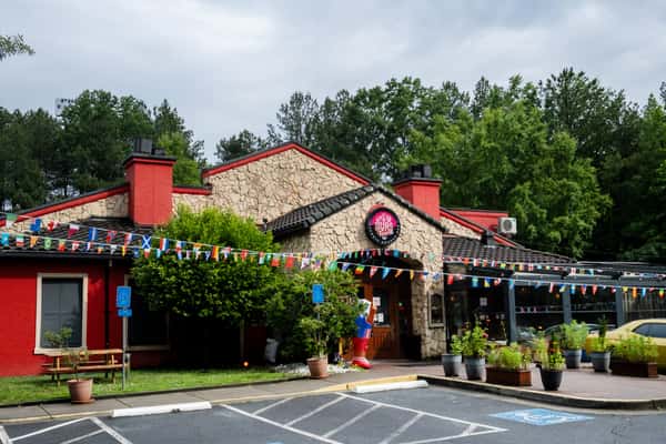 Exterior of Sivas Tavern in Kennesaw with colorful entrance, festive decor, and parking lot