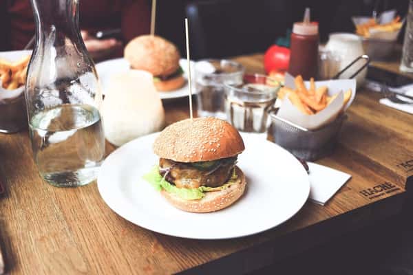 Cheeseburger and fries meal at Sivas Tavern with casual dining setup and classic American comfort food
