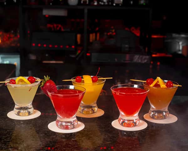 Colorful handcrafted cocktails lined up at the bar inside Sivas Tavern with vibrant nightlife and lounge atmosphere