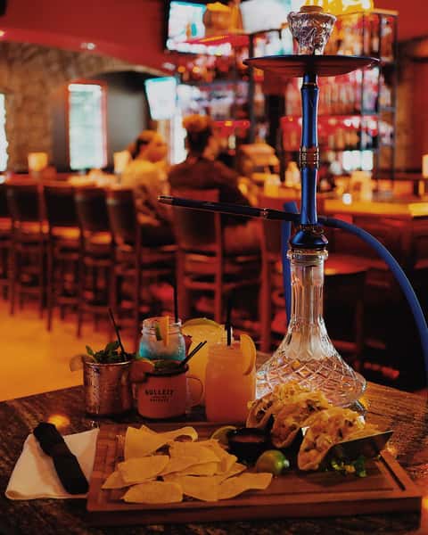 Hookah setup and cocktails at Sivas Tavern featuring upscale lounge seating and nightlife ambiance