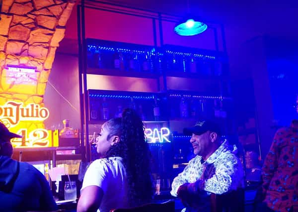 Guests enjoying nightlife at Sivas Tavern with colorful lighting, music, and energetic lounge atmosphere