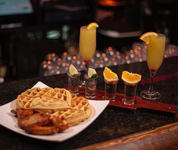 Waffles and signature cocktails at Sivas Tavern featuring brunch dining and vibrant nightlife atmosphere