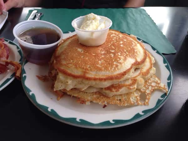 stack of pancakes with butter and syrup