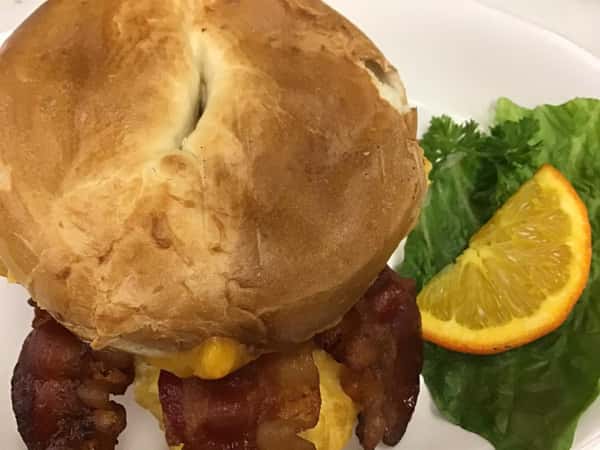 bacon and egg sandwich with side of garnish