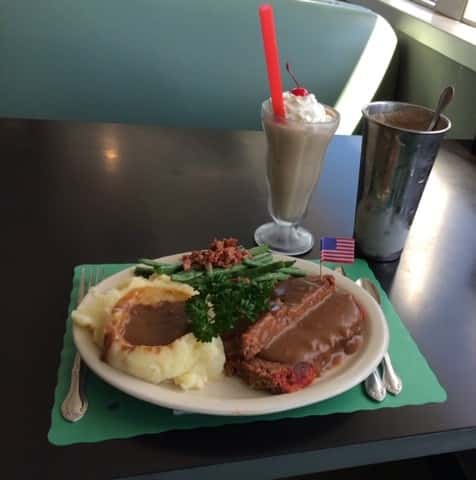meatloaf and mashed potatoes with gravy and a chocolate shake
