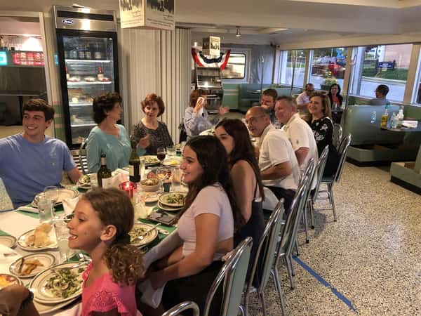 a party of over 10 guests, seated at combined tables