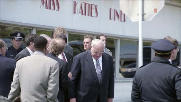 several people in suits outside the diner